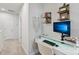 Bright home office featuring wall shelving, modern computer setup, and neutral colors at 5324 Somerset Hill Ln, Charlotte, NC 28269