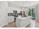 Modern kitchen boasts white cabinets, stainless steel appliances, and a large island with pendant lighting at 5324 Somerset Hill Ln, Charlotte, NC 28269