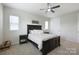 Cozy main bedroom with a large bed, decorative pillows, and a ceiling fan for added comfort at 5324 Somerset Hill Ln, Charlotte, NC 28269