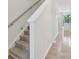 Carpeted stairway leading to the upper level with a white banister at 5324 Somerset Hill Ln, Charlotte, NC 28269