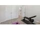 Bright workout room featuring free weights and view into bathroom at 5324 Somerset Hill Ln, Charlotte, NC 28269
