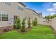 This backyard features a patio, landscaping, new sod, and a privacy fence at 5332 Orchid Bloom Dr, Indian Land, SC 29707