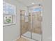 Bathroom featuring a glass door shower with tile walls and a window offering natural light at 5332 Orchid Bloom Dr, Indian Land, SC 29707