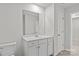 A clean bathroom featuring a single vanity sink, mirror, and toilet at 5332 Orchid Bloom Dr, Indian Land, SC 29707