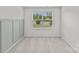Bright bedroom with light-gray carpet, board and batten accent wall and large window views at 5332 Orchid Bloom Dr, Indian Land, SC 29707