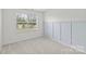 Bright bedroom with a large window and a soothing color palette on the wall at 5332 Orchid Bloom Dr, Indian Land, SC 29707