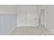 Bedroom with light blue wall paneling, double doors to closet, and an open door at 5332 Orchid Bloom Dr, Indian Land, SC 29707