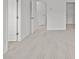 A bright bedroom features neutral walls and carpet, with open doors leading to other rooms at 5332 Orchid Bloom Dr, Indian Land, SC 29707