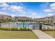 The neighborhood pool with lounge chairs and manicured landscaping at 5332 Orchid Bloom Dr, Indian Land, SC 29707