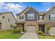 Charming two-story townhome featuring a brick facade, attached garage, and well-maintained lawn at 5332 Orchid Bloom Dr, Indian Land, SC 29707