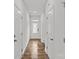 Bright hallway with hardwood floors and white doors that create a seamless, modern look throughout the home at 5332 Orchid Bloom Dr, Indian Land, SC 29707
