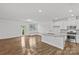 Open-concept living space with a modern kitchen, a cozy breakfast nook, and a sliding door to the outdoor area at 5332 Orchid Bloom Dr, Indian Land, SC 29707