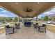Covered patio with comfortable seating, ceiling fans, and views of the surrounding neighborhood at 5332 Orchid Bloom Dr, Indian Land, SC 29707