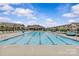 Community pool featuring lounge chairs, shade umbrellas, and a covered gathering place for neighborhood residents at 5332 Orchid Bloom Dr, Indian Land, SC 29707