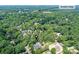 Aerial view showcases the home's location near Davidson College with a canopy of trees at 541 Greenway St, Davidson, NC 28036