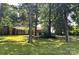 Beautiful single-story home with a lush, green lawn, mature trees, and a detached garage; perfect blend of comfort and nature at 541 Greenway St, Davidson, NC 28036