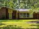 Charming brick home featuring a well-maintained lawn and mature trees, creating a welcoming and picturesque setting at 541 Greenway St, Davidson, NC 28036