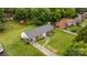 Well-maintained home with green lawn, a carport and a long driveway at 5918 Barrington Dr, Charlotte, NC 28215
