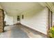 Covered back porch featuring brick columns and white siding at 5918 Barrington Dr, Charlotte, NC 28215