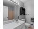 Neutral bathroom featuring a sink, toilet, and shower with tile surround at 5918 Barrington Dr, Charlotte, NC 28215