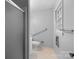 Bathroom featuring shower with grab bar, toilet, and window for natural light at 5918 Barrington Dr, Charlotte, NC 28215