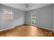 Neutral bedroom featuring hardwood floors, ceiling fan, and natural light at 5918 Barrington Dr, Charlotte, NC 28215