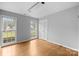 Bright bedroom with hardwood floors, natural light, and two windows at 5918 Barrington Dr, Charlotte, NC 28215