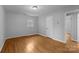 Clean bedroom with hardwood floors and natural light from two windows at 5918 Barrington Dr, Charlotte, NC 28215