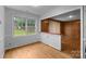 Bright dining room with hardwood floors and a large window overlooking the yard at 5918 Barrington Dr, Charlotte, NC 28215