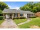Beautiful brick home with an attached carport and manicured landscaping at 5918 Barrington Dr, Charlotte, NC 28215