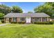 Charming brick home with manicured lawn, shutters and bright white front door at 5918 Barrington Dr, Charlotte, NC 28215