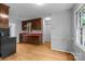 Cozy kitchen featuring wood cabinets, red countertops, and hardwood floors at 5918 Barrington Dr, Charlotte, NC 28215