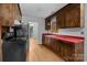 Traditional kitchen with wood cabinets, stainless steel appliances, and red countertops at 5918 Barrington Dr, Charlotte, NC 28215