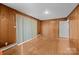 Spacious living room with hardwood floors and wood paneled walls at 5918 Barrington Dr, Charlotte, NC 28215