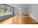 Bright living room with beautiful hardwood floors and large windows at 5918 Barrington Dr, Charlotte, NC 28215