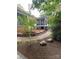 Exterior of home featuring a landscaped backyard with a stone walkway and covered porch at 5929 Waterelm Ln, Charlotte, NC 28269