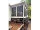 Exterior of house with a screened-in porch above an elevated patio, landscaping and stone walkway at 5929 Waterelm Ln, Charlotte, NC 28269