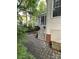 Landscaped backyard with a screened porch, steps, and paved patio at 5929 Waterelm Ln, Charlotte, NC 28269