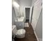 Bathroom featuring white cabinets, a toilet, and hardwood floors at 5929 Waterelm Ln, Charlotte, NC 28269