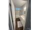 Bathroom with white cabinets, shower with subway tile, and hardwood floors at 5929 Waterelm Ln, Charlotte, NC 28269