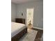 Bedroom with adjacent bathroom, neutral colors, and hardwood floors at 5929 Waterelm Ln, Charlotte, NC 28269