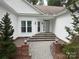Close up of home entrance highlighting the stone steps and tidy landscaping at 5929 Waterelm Ln, Charlotte, NC 28269