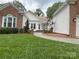 Charming walkway leading to the front door, complimented by lush green lawn and mature landscaping at 5929 Waterelm Ln, Charlotte, NC 28269