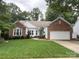 Beautiful single-Gathering home featuring brick and white siding, a well-manicured lawn, and attached two-car garage at 5929 Waterelm Ln, Charlotte, NC 28269