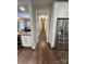 Hallway view into the kitchen and a dining area, featuring stainless steel appliances at 5929 Waterelm Ln, Charlotte, NC 28269