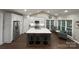 Bright kitchen with large island, stainless steel appliances, white cabinets, and wood flooring at 5929 Waterelm Ln, Charlotte, NC 28269