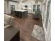 Open concept living room and kitchen area featuring dark wood floors and ample lighting at 5929 Waterelm Ln, Charlotte, NC 28269