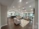 Open-concept living space with views of the kitchen, living room, and access to the outdoor area at 5929 Waterelm Ln, Charlotte, NC 28269