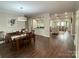Open concept dining and living spaces featuring hardwood floors, modern lighting, and neutral decor at 5929 Waterelm Ln, Charlotte, NC 28269