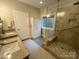 Main bathroom with double sinks, a separate shower, and a linen closet for storage at 5929 Waterelm Ln, Charlotte, NC 28269